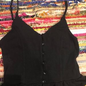 Cropped tank top. Black with ruffles and buttons down the side. New not worn